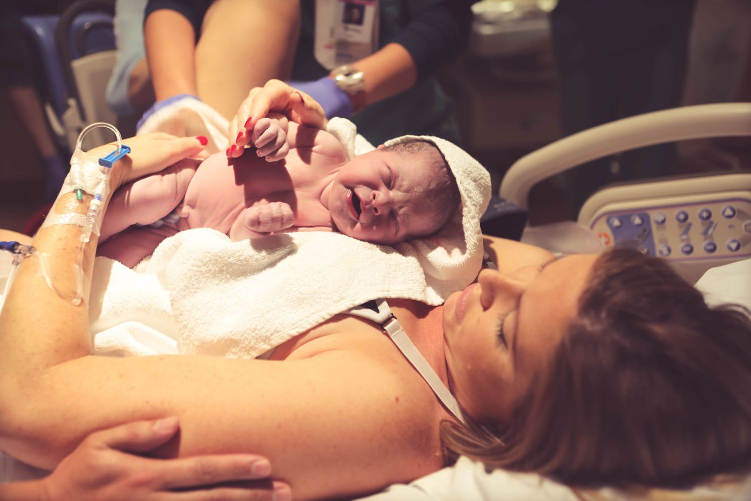 Tucson Fresh 48 newborn photography capturing a mother holding her newborn twins immediately after delivery.