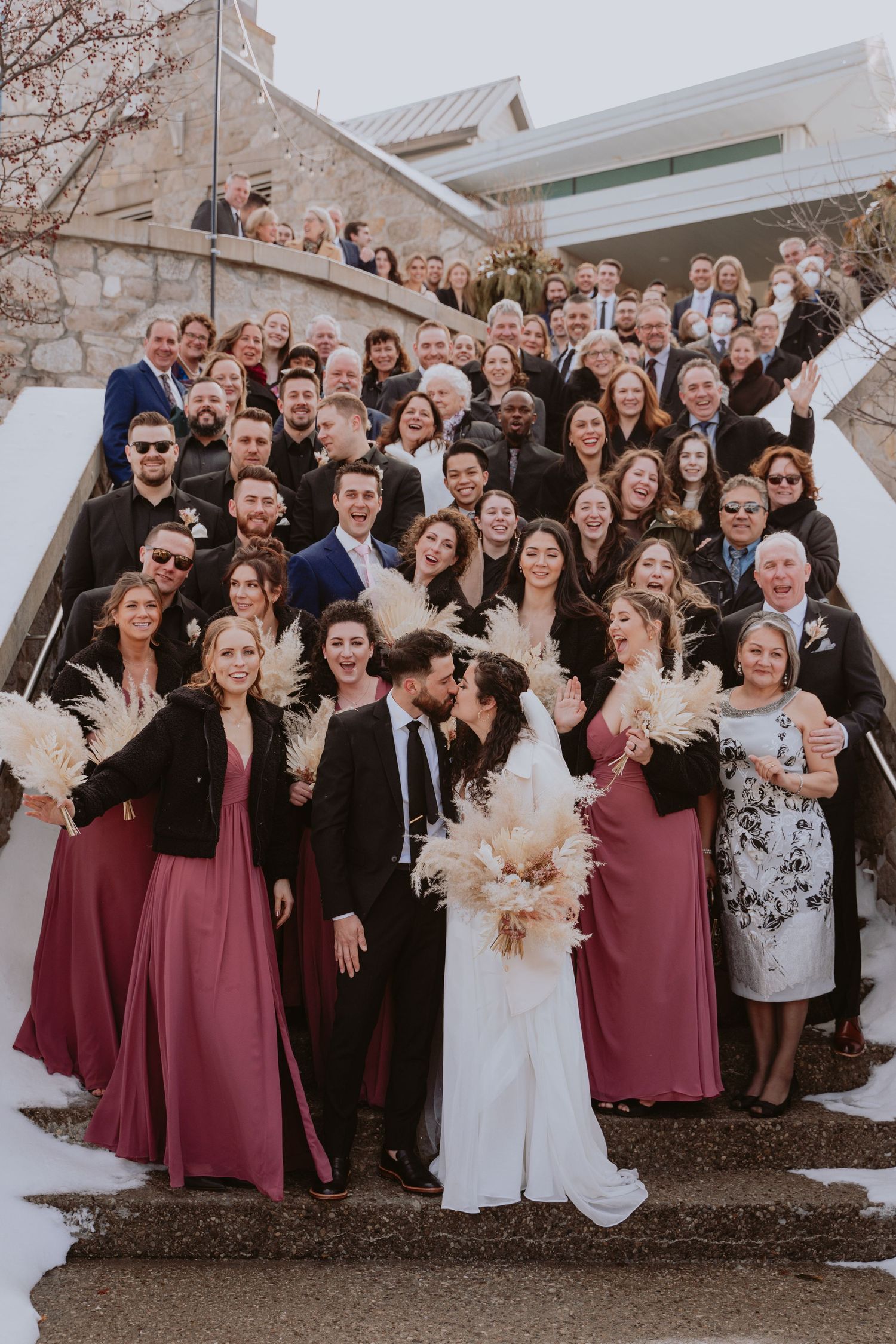 Image of entire wedding party and guests on stairs.