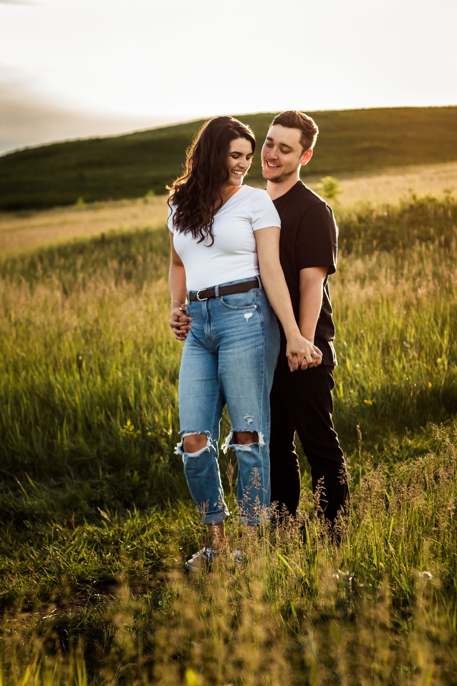 Lifestyle photography: Casual summer engagement photos during golden hour at Nose Hill Park in Calgary.