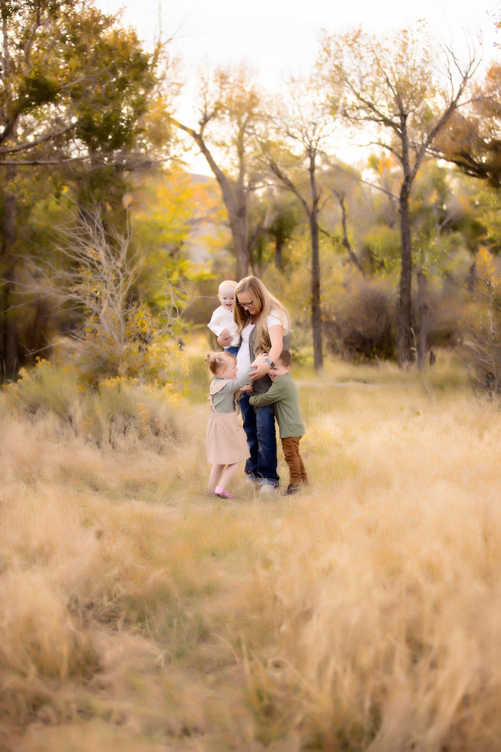 A tender moment captured between two people embracing in a golden autumn field.