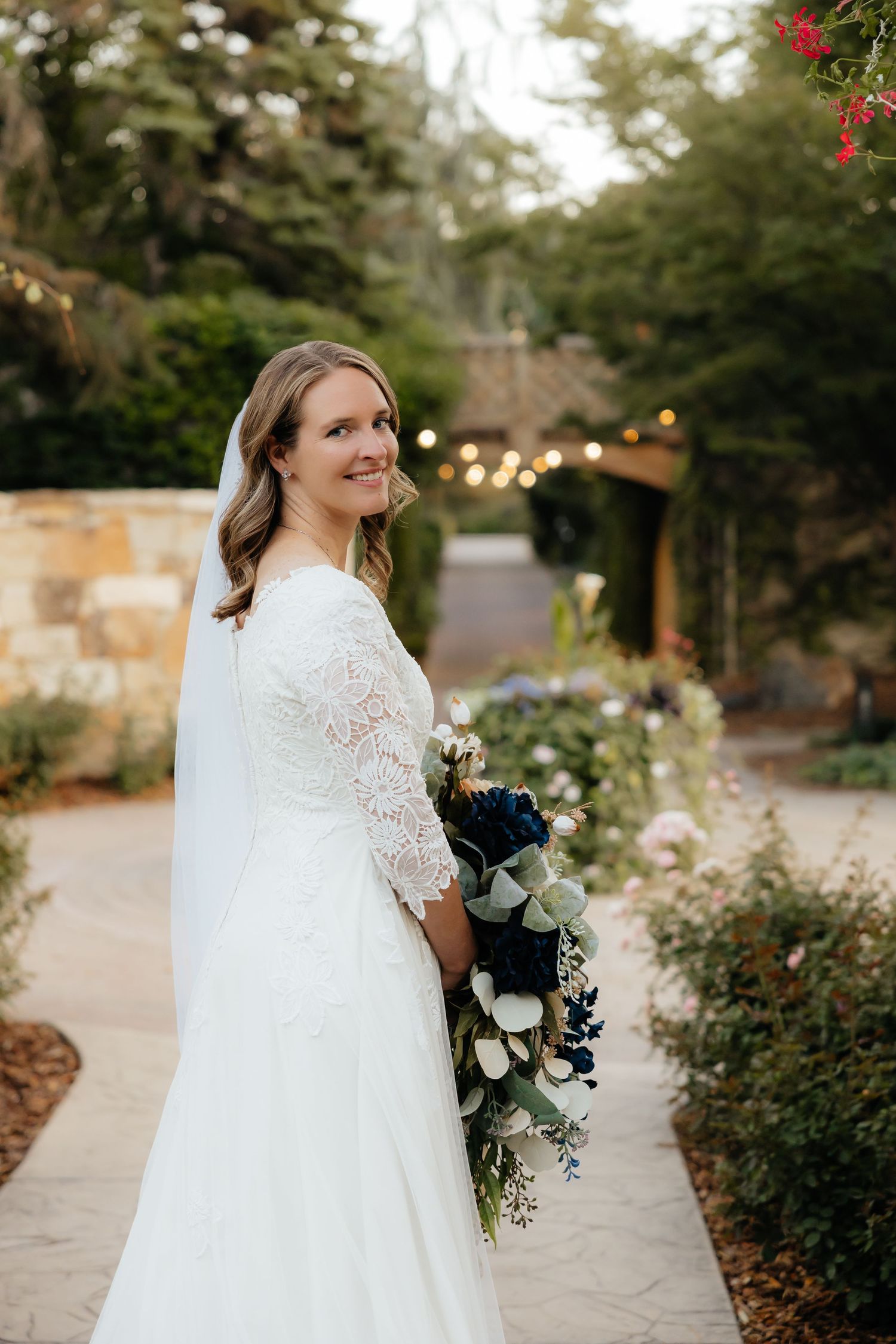 Bride looking over her shoulder in a garden