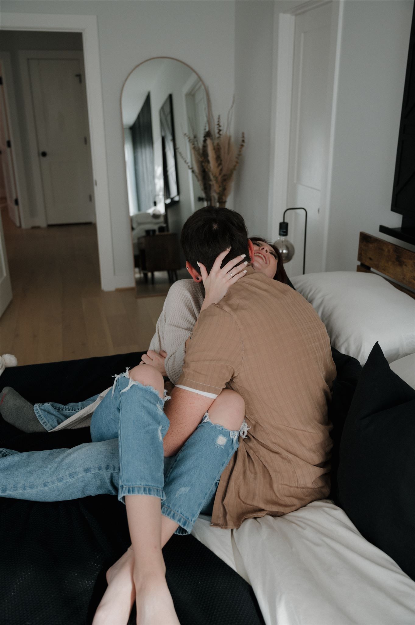 An intimate embrace captured on a cozy bed with modern bedroom decor.