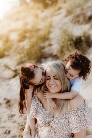 Intimate family moments captured in warm golden light on a beach.