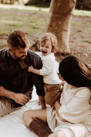 A playful family moment captured in a series of candid photos showing affection and laughter.