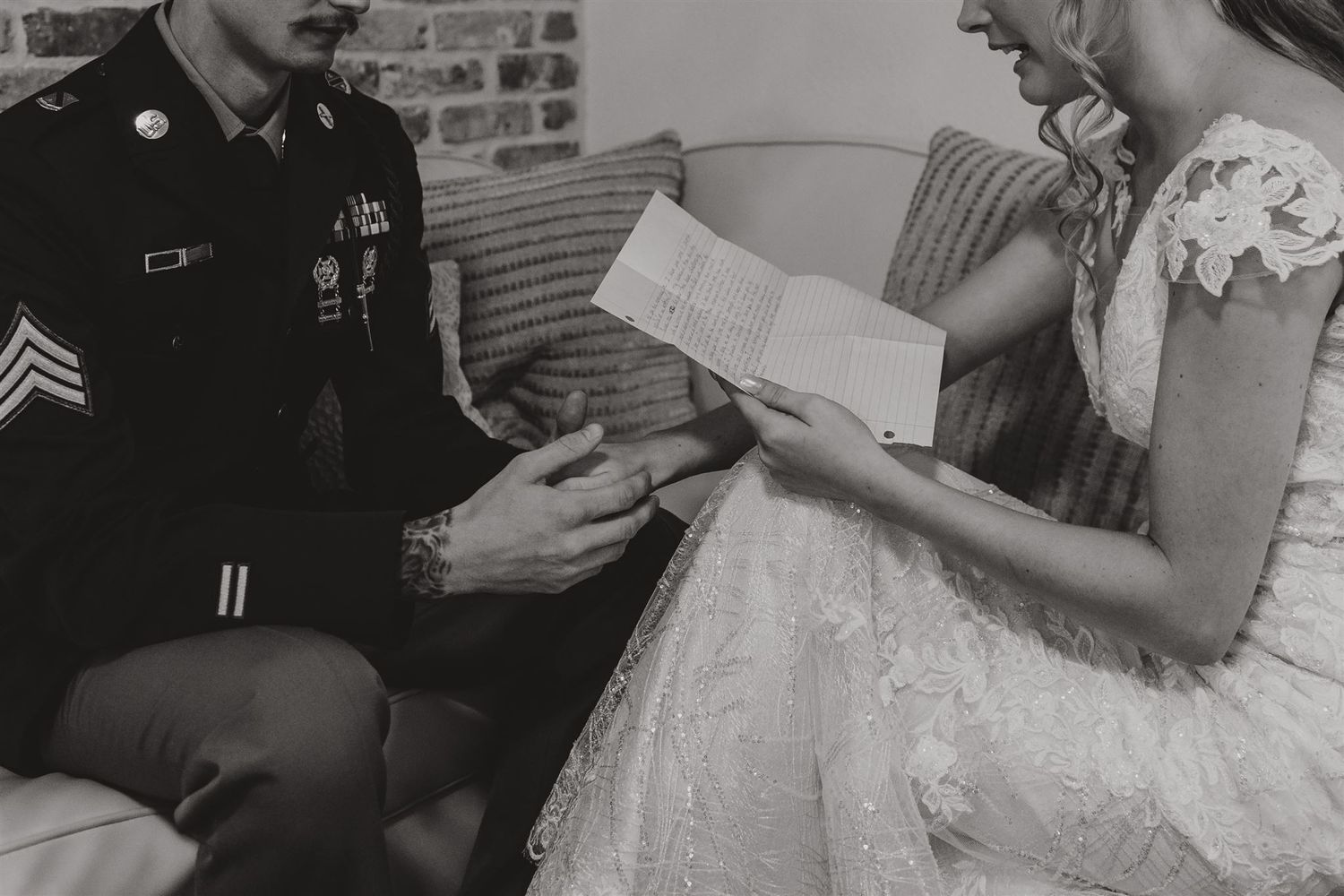 Military ceremony with couple reading documents in intimate black and white photo.