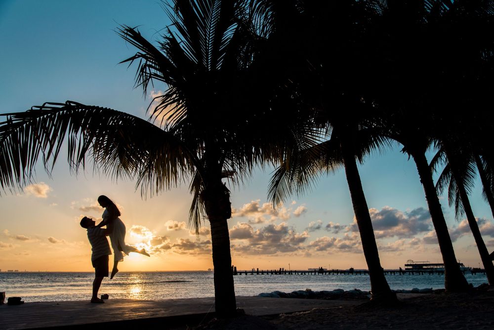 Silhouette of Maureen and John against the breathtaking Isla Mujeres sunset