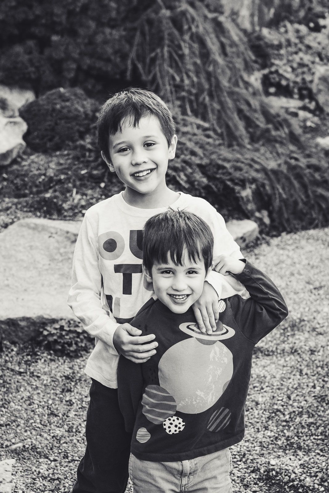 Two brothers hugging each other in Bellevue Botanical Garden