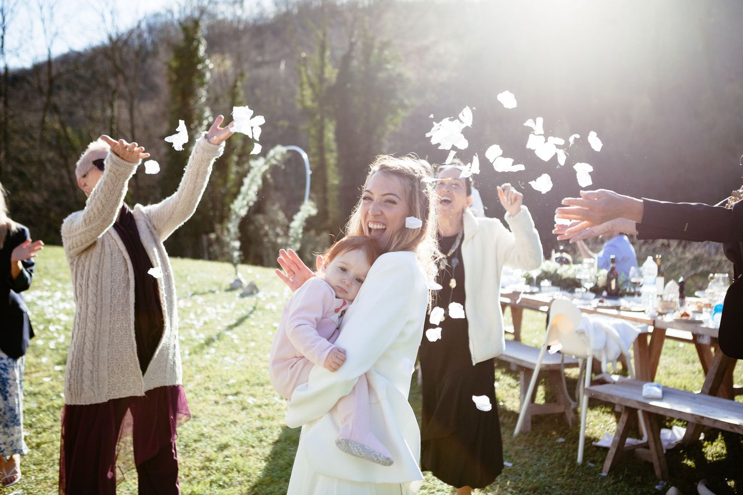 Confetti is thrown on a bride and her young daughter while dancing.