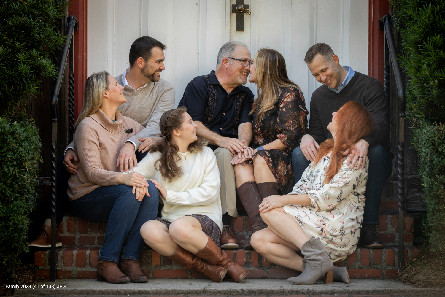 Multi generation family on front steps of house