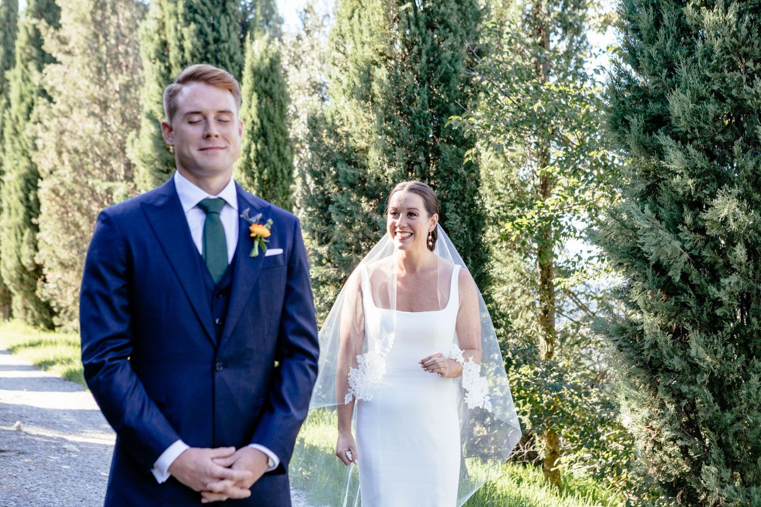 The groom closes his eyes before the first look at his bride for their wedding at The Lazy Olive in Tuscany.