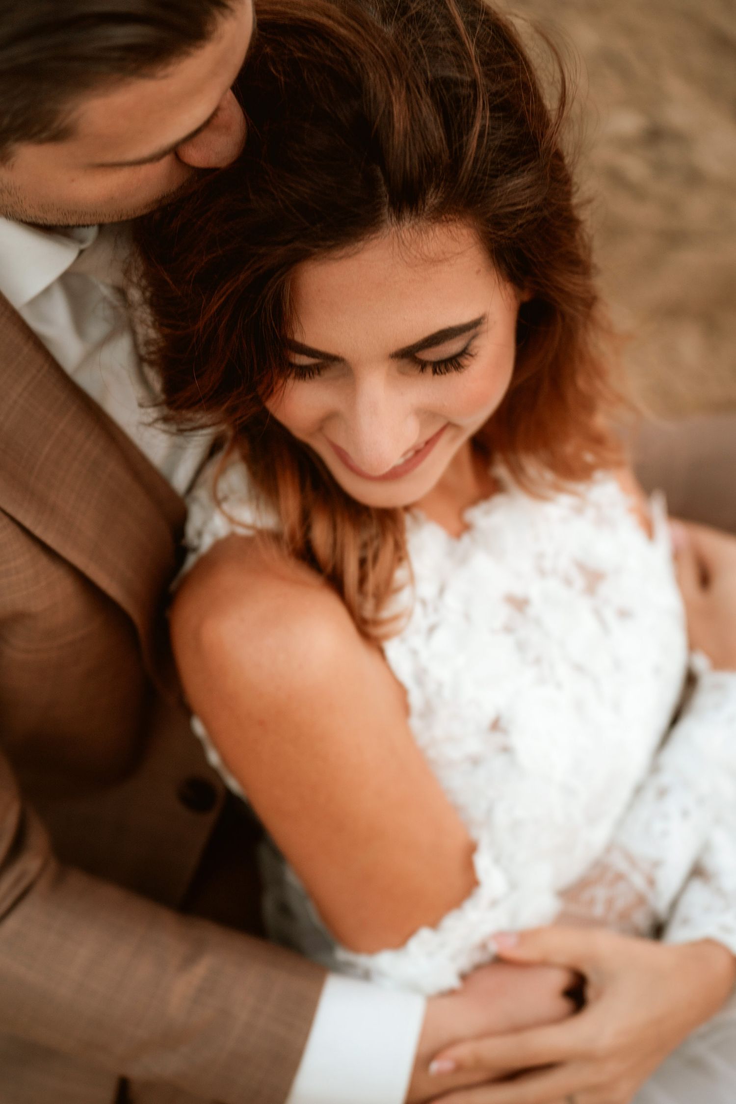 An intimate moment captured between newlyweds in warm sunset lighting.