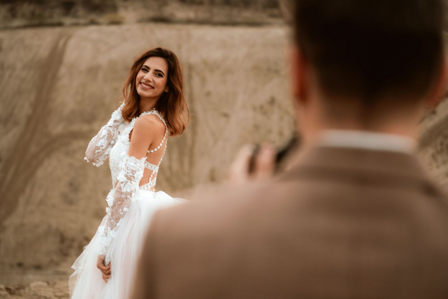 Joyful moment captured during desert wedding photoshoot with couple sharing laughter.