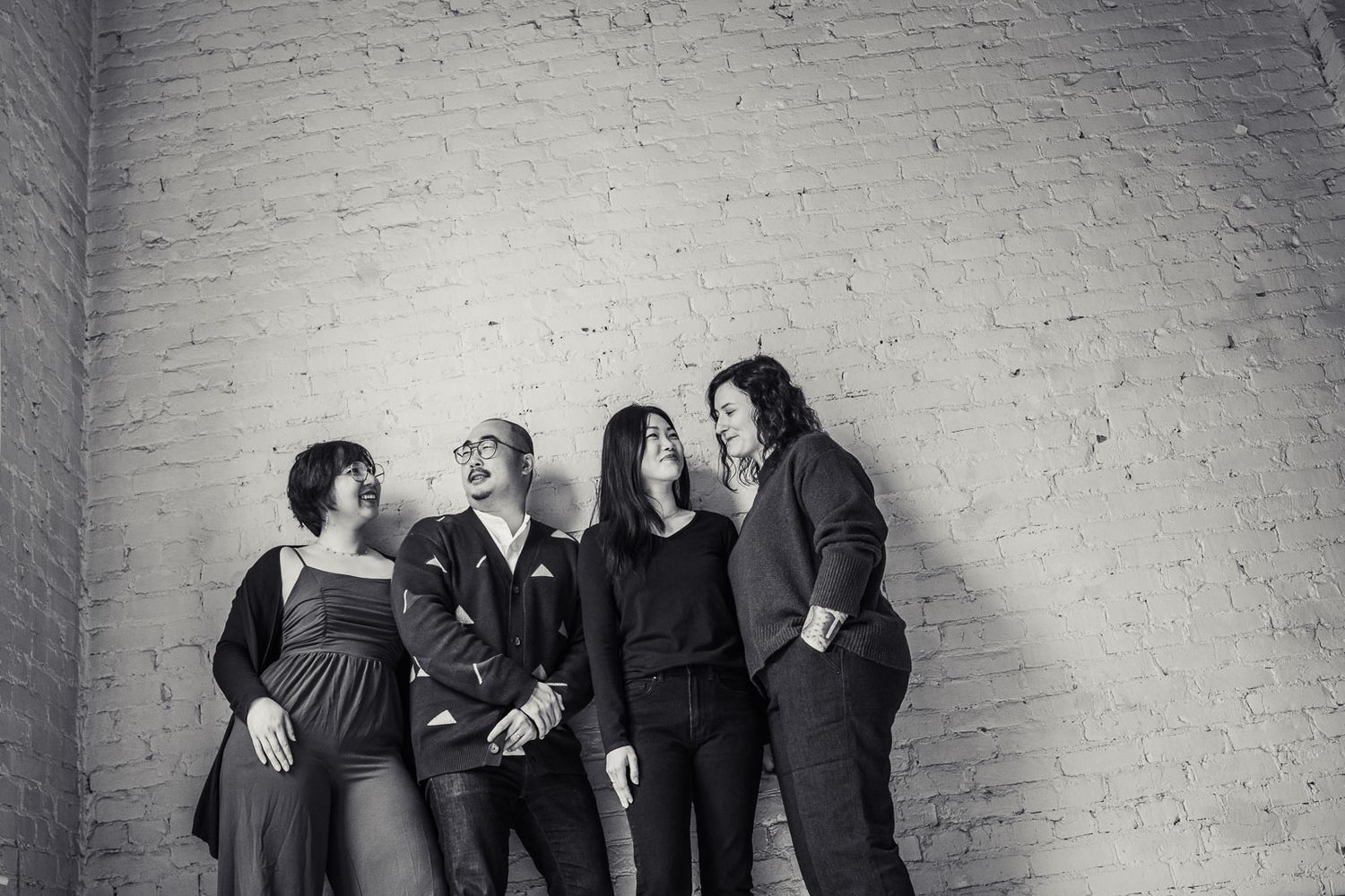 Black and white candid of a group of young people smiling