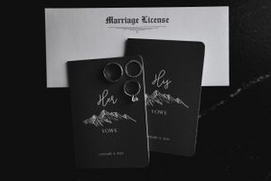 Marriage license and wedding stationery featuring mountain designs in black and white.
