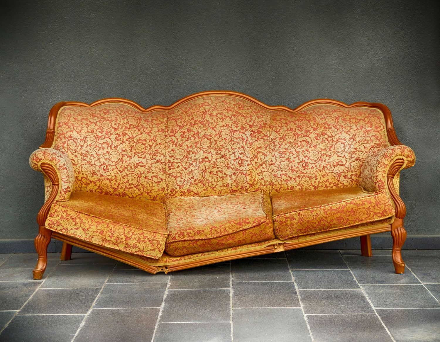 Broken orange couch - purchase a furniture protection plan