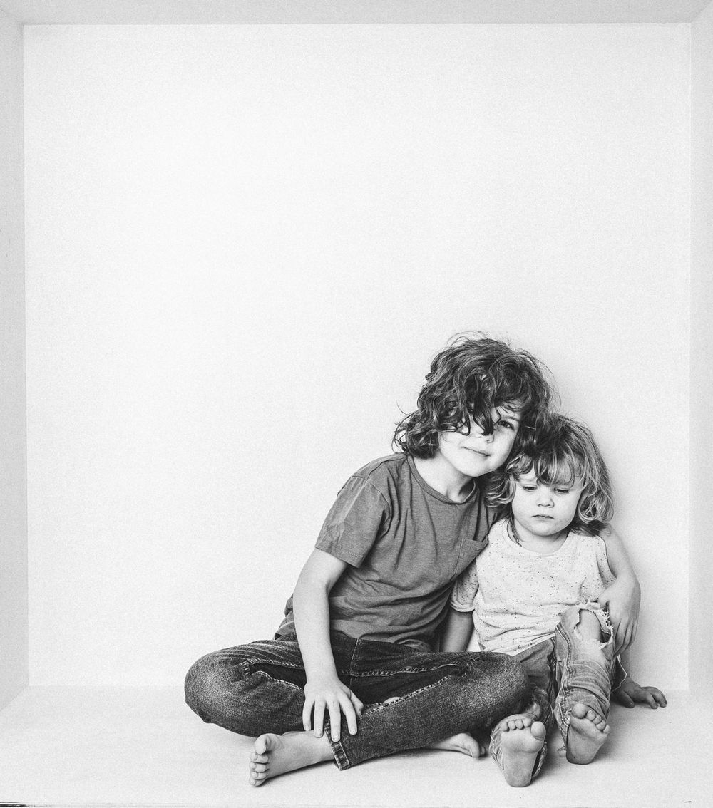 2 little boys close together hugging