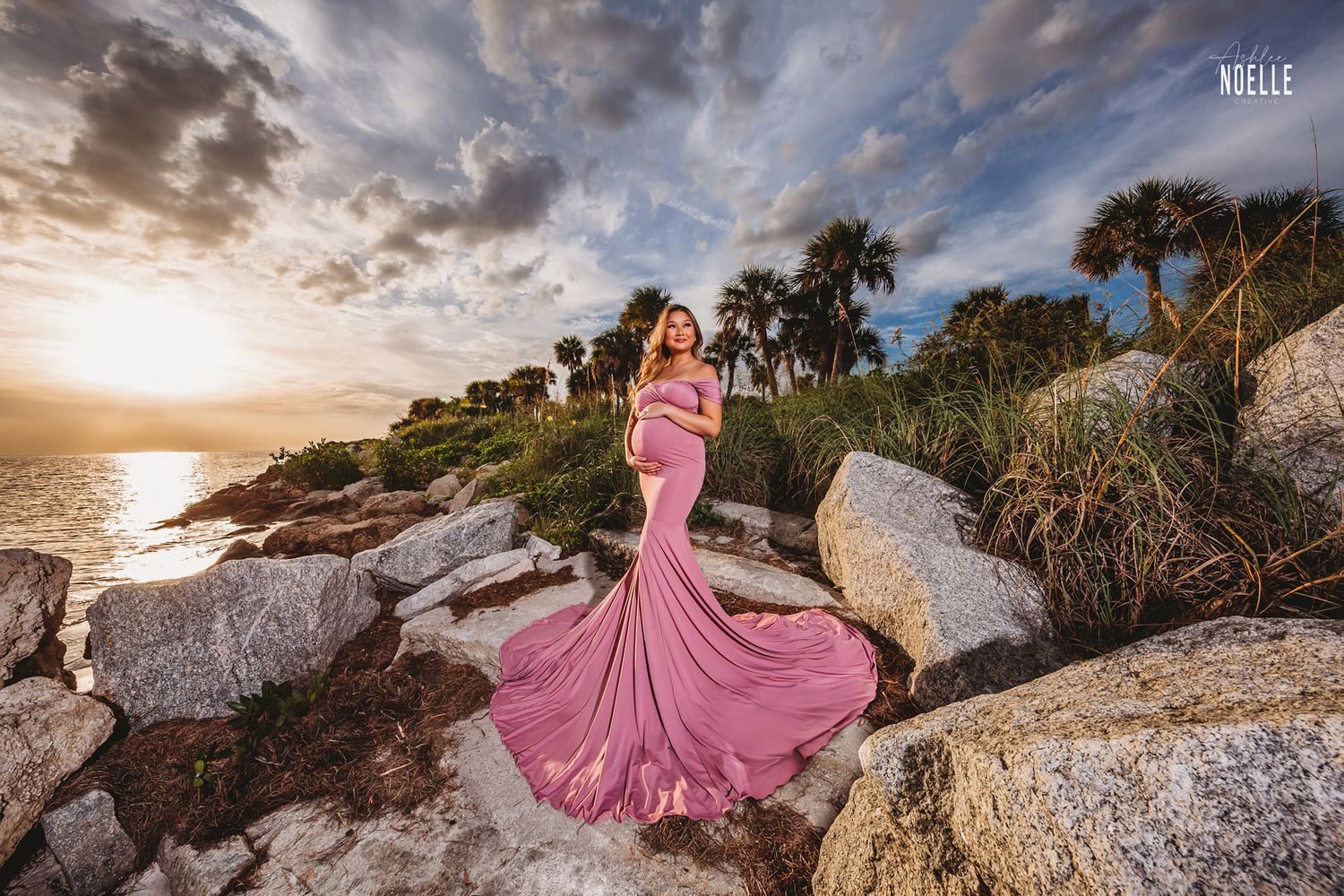 Tampa Maternity Photographer- Pregnant woman in pink dress poses at sunset on the beach