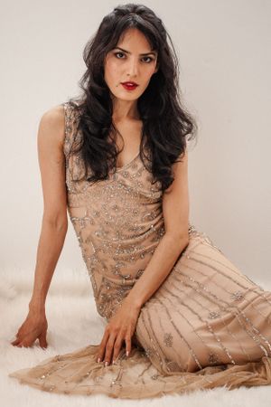 Woman in sequin gown backlit by the sun