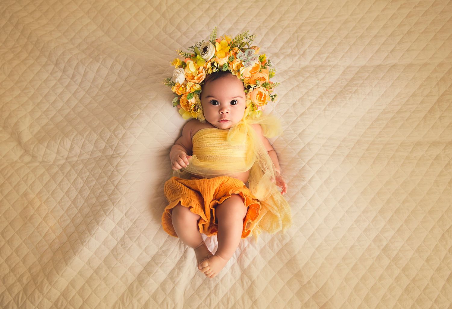 baby girl in yellow with floral bonnet