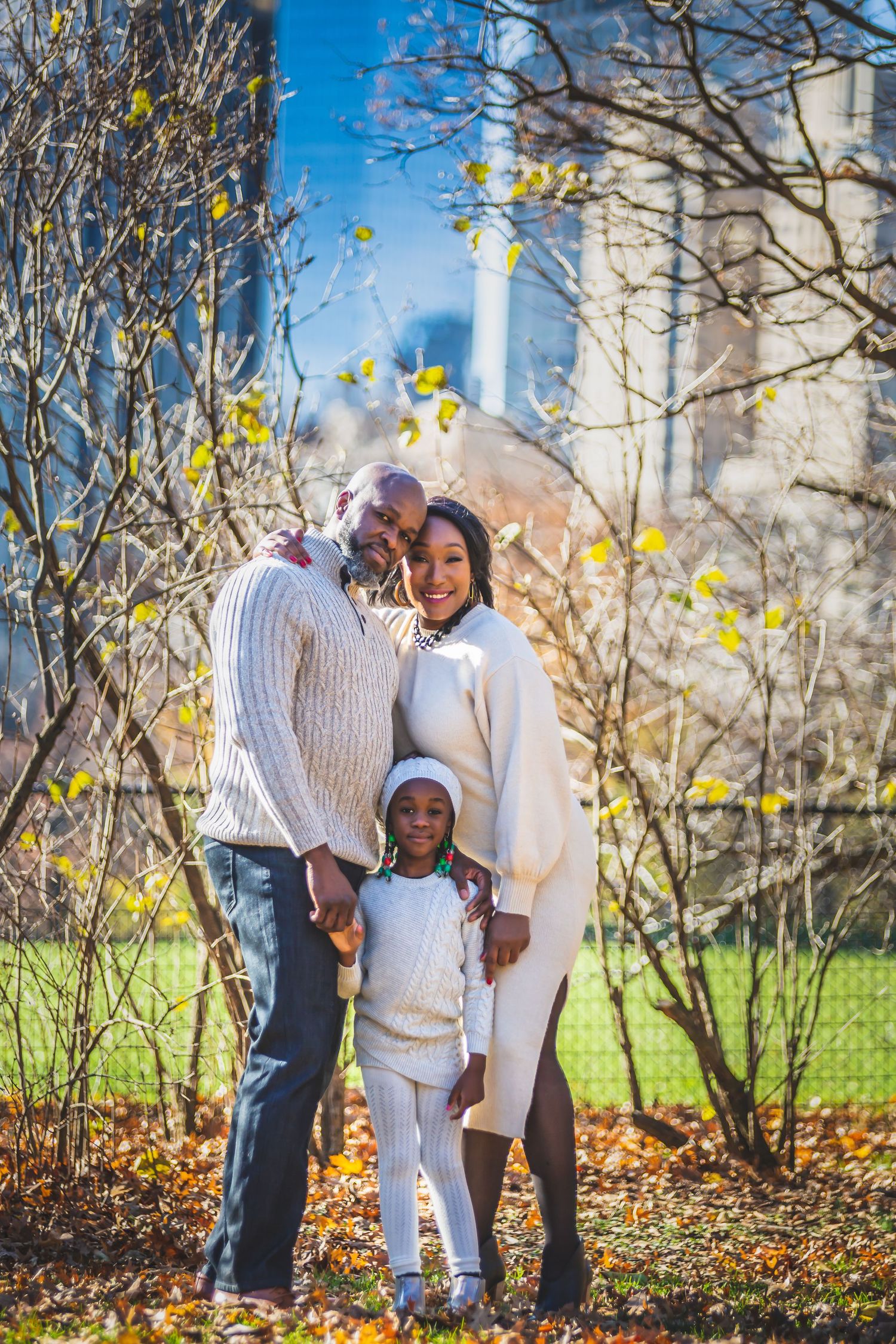 father, mother and daughter in park