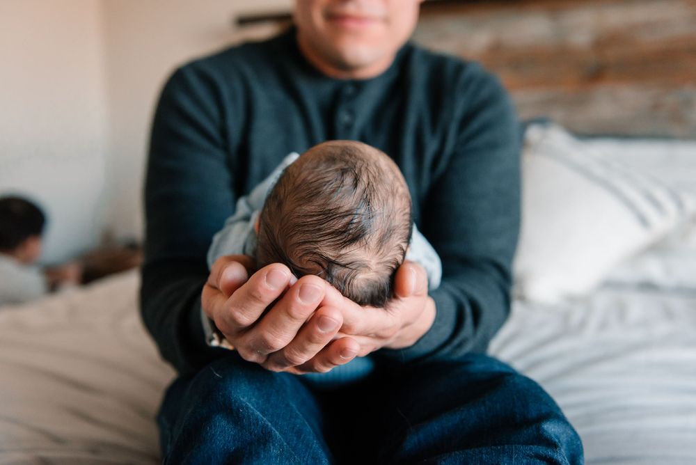 Close-up shots of gentle parental interaction with a newborn.