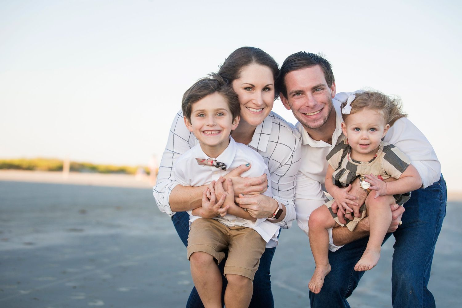 A casual family photo session against a light background.