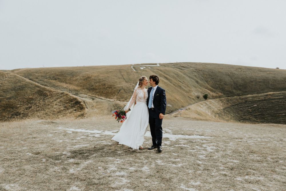 Wedding bride and groom portraits at Uffington White Horse in Oxfordshire