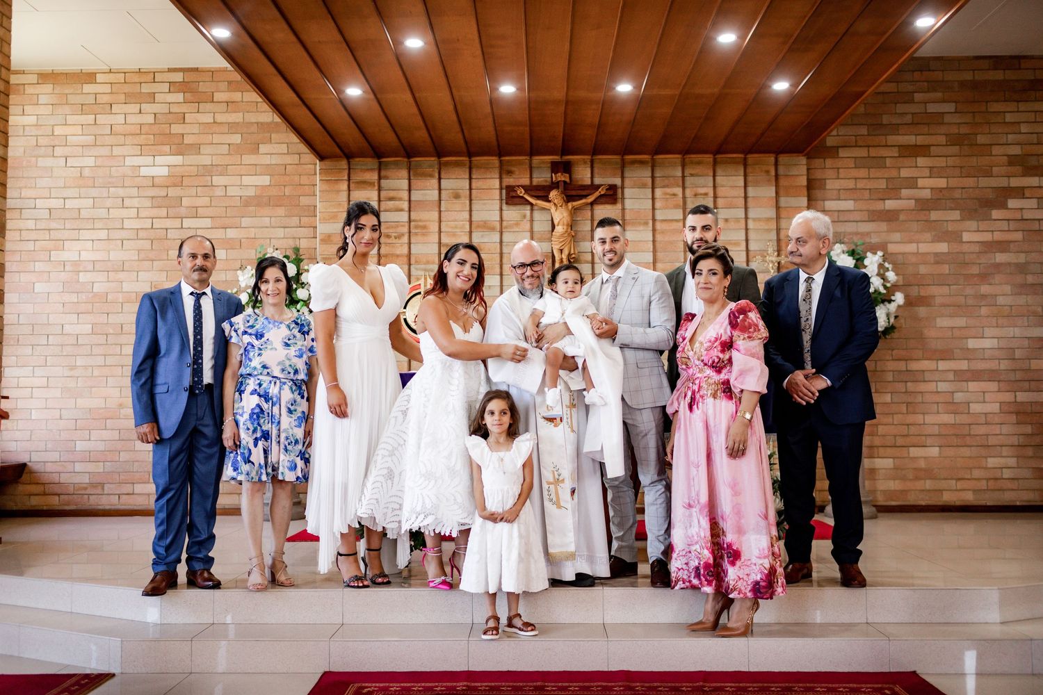 Modern church interior with exposed brick walls and wooden ceiling during a baptism celebration.