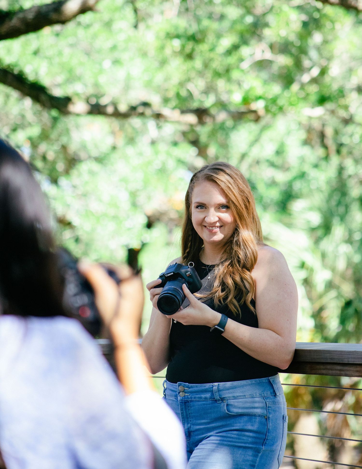 Branding photo of girl with camera in hand.