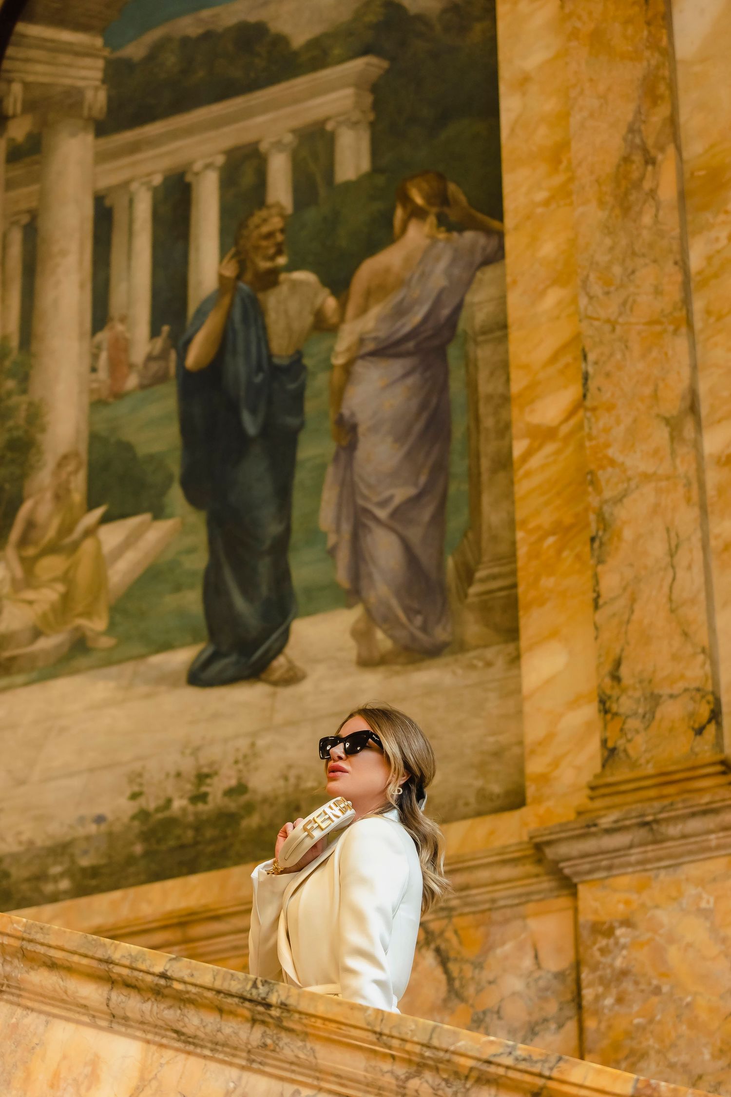 Artistic portrait series against ornate classical murals and architecture.