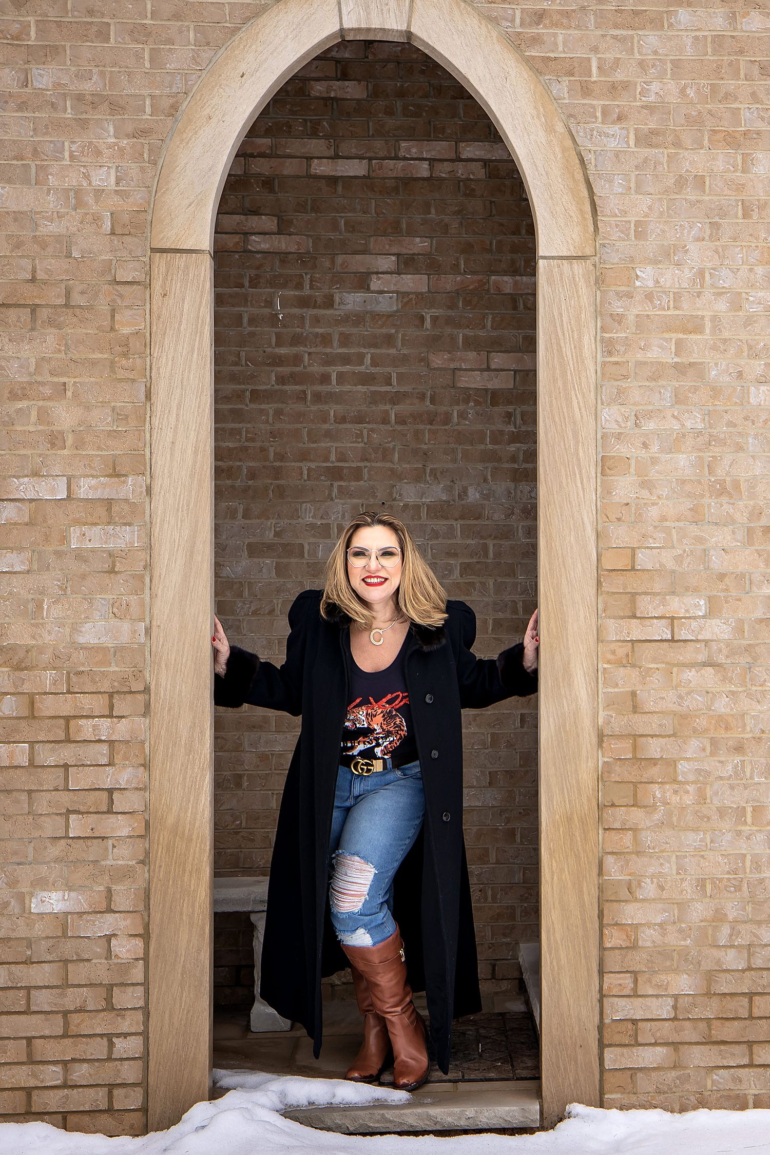 Architectural photoshoot featuring brick archways and stone columns.