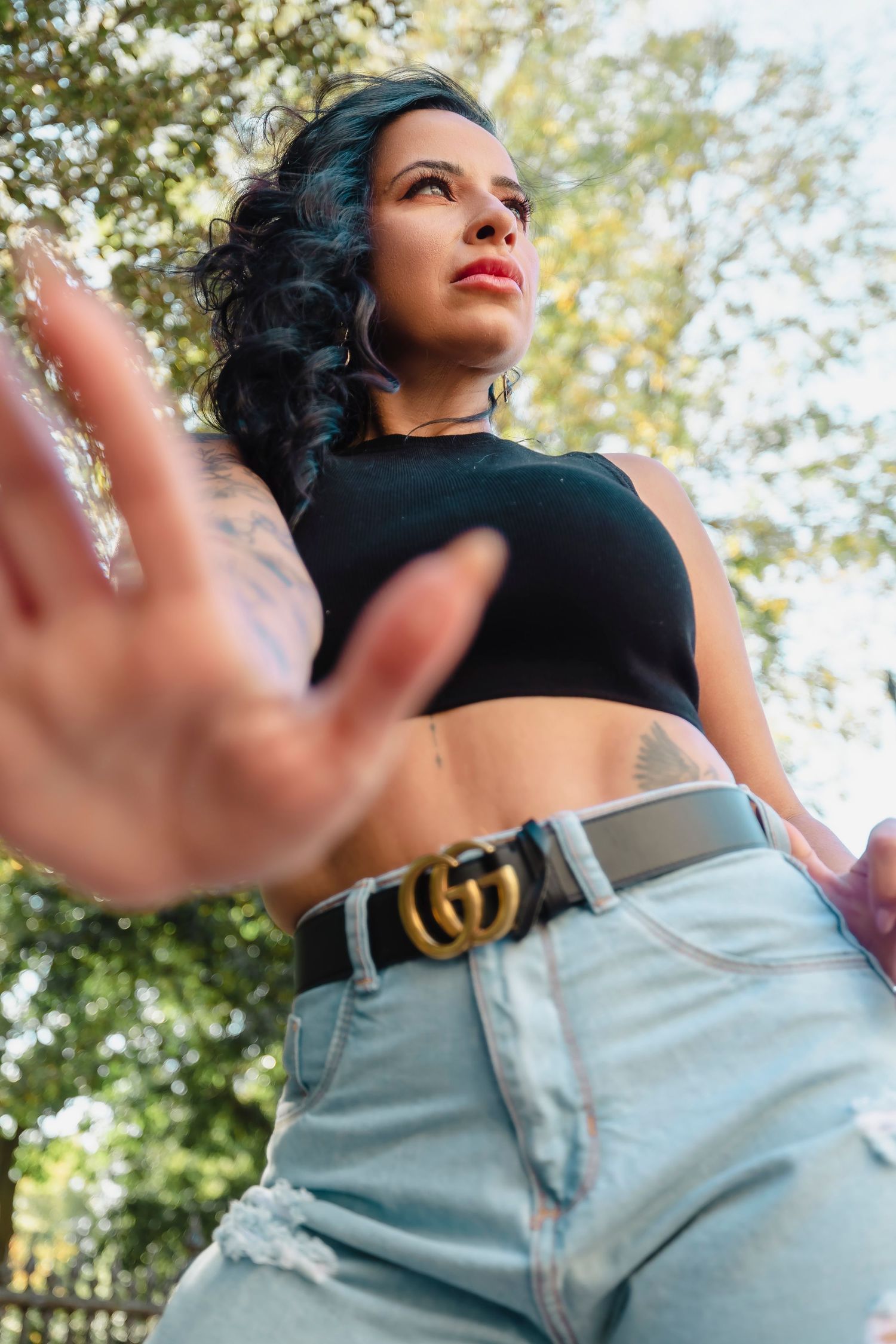 Dynamic outdoor portrait series featuring casual denim and black crop top styling.