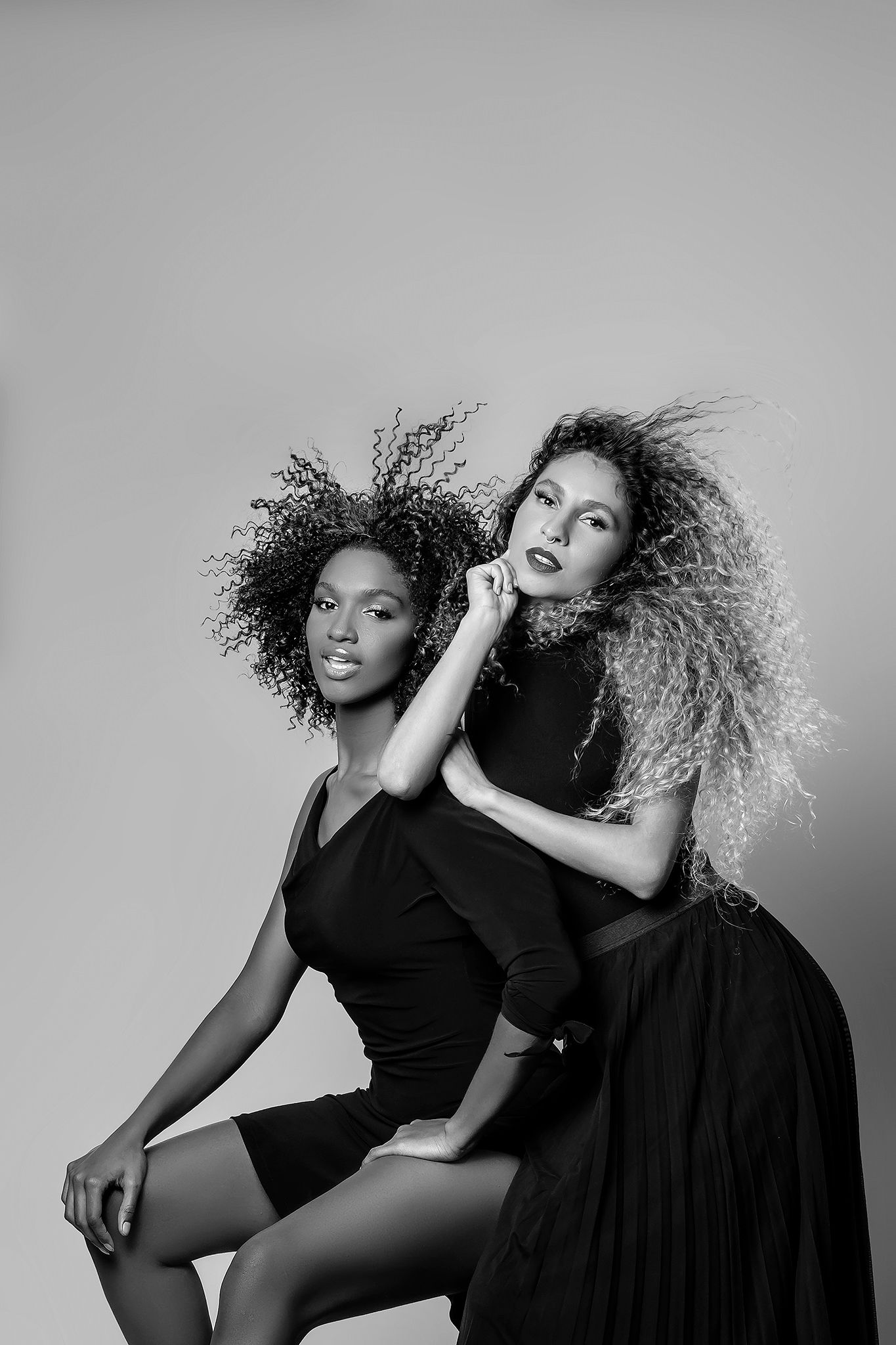 Dramatic black and white studio photos with artistic poses in black attire.