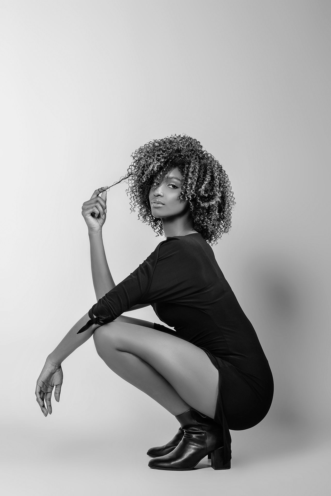 Minimalist black and white portraits with artistic poses on studio backdrop.