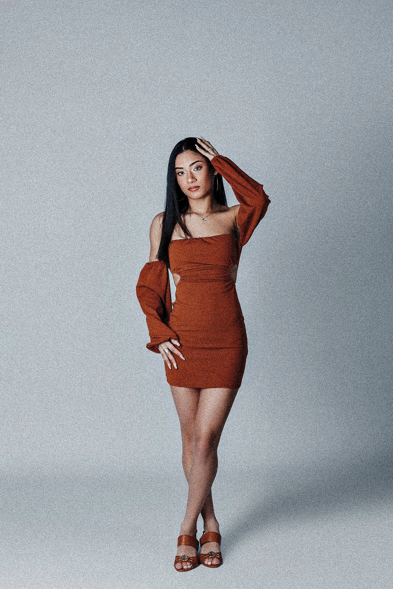 Fashion photo sequence showing poses in a rust-colored sweater dress against a gray backdrop.