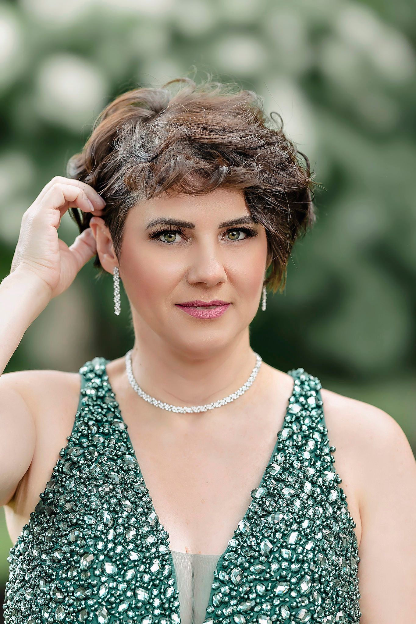 Glamorous portrait series in sparkly green dress with jewelry.