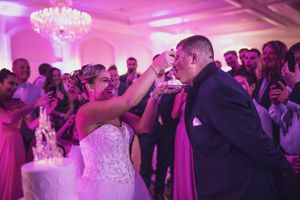 Bride feeding groom cake