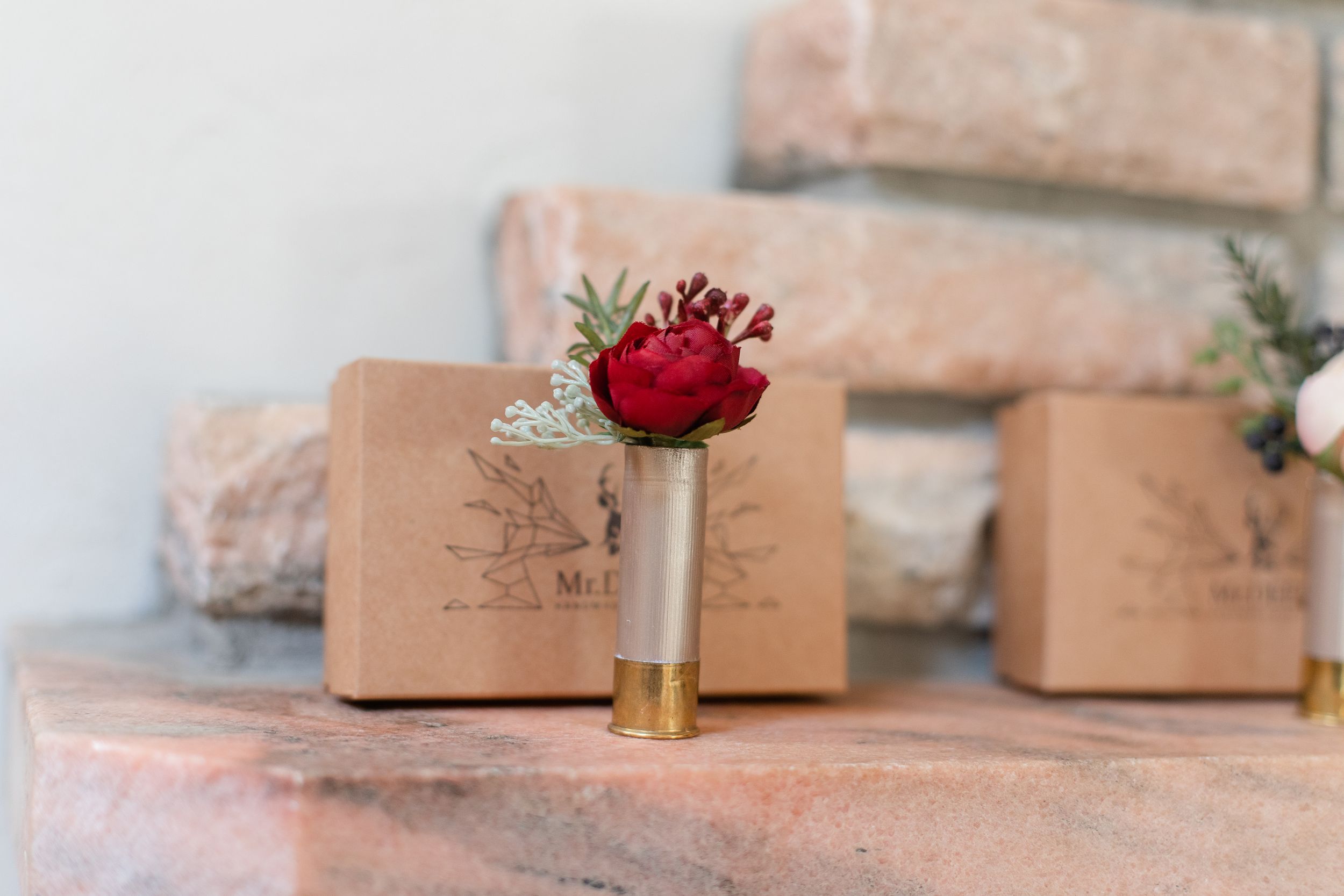 Rustic kraft paper gift boxes arranged in a row with red floral accents.
