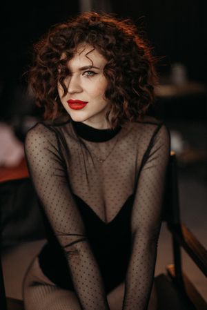 Glamorous portraits in a sheer polka dot top with classic red lipstick.