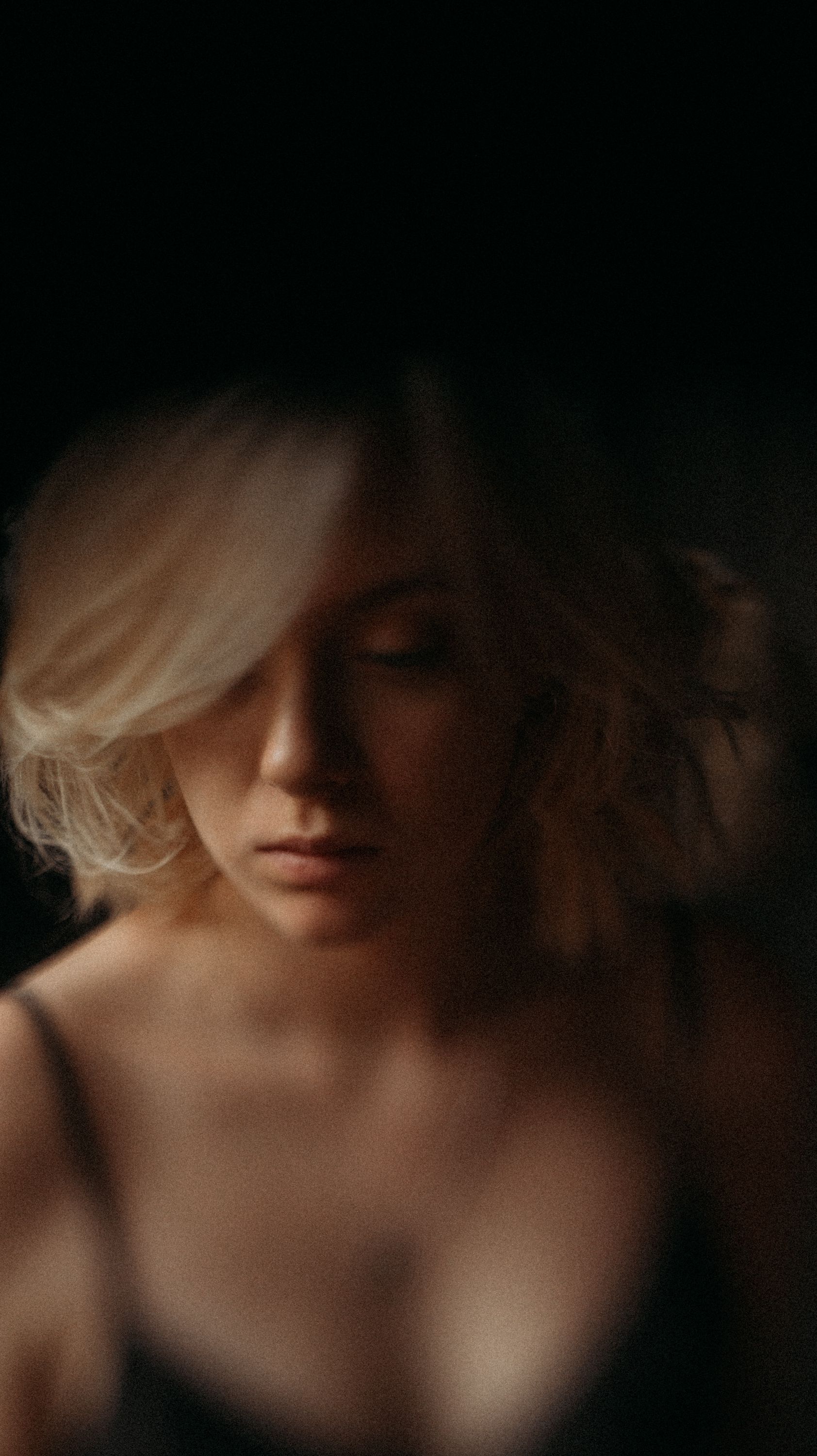 Intimate portrait series with soft focus and dramatic shadows in warm lighting.