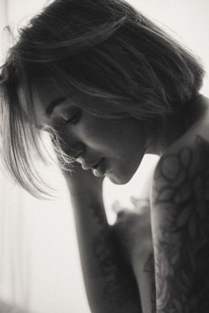 Moody black and white portrait series with dramatic shadows and lighting.