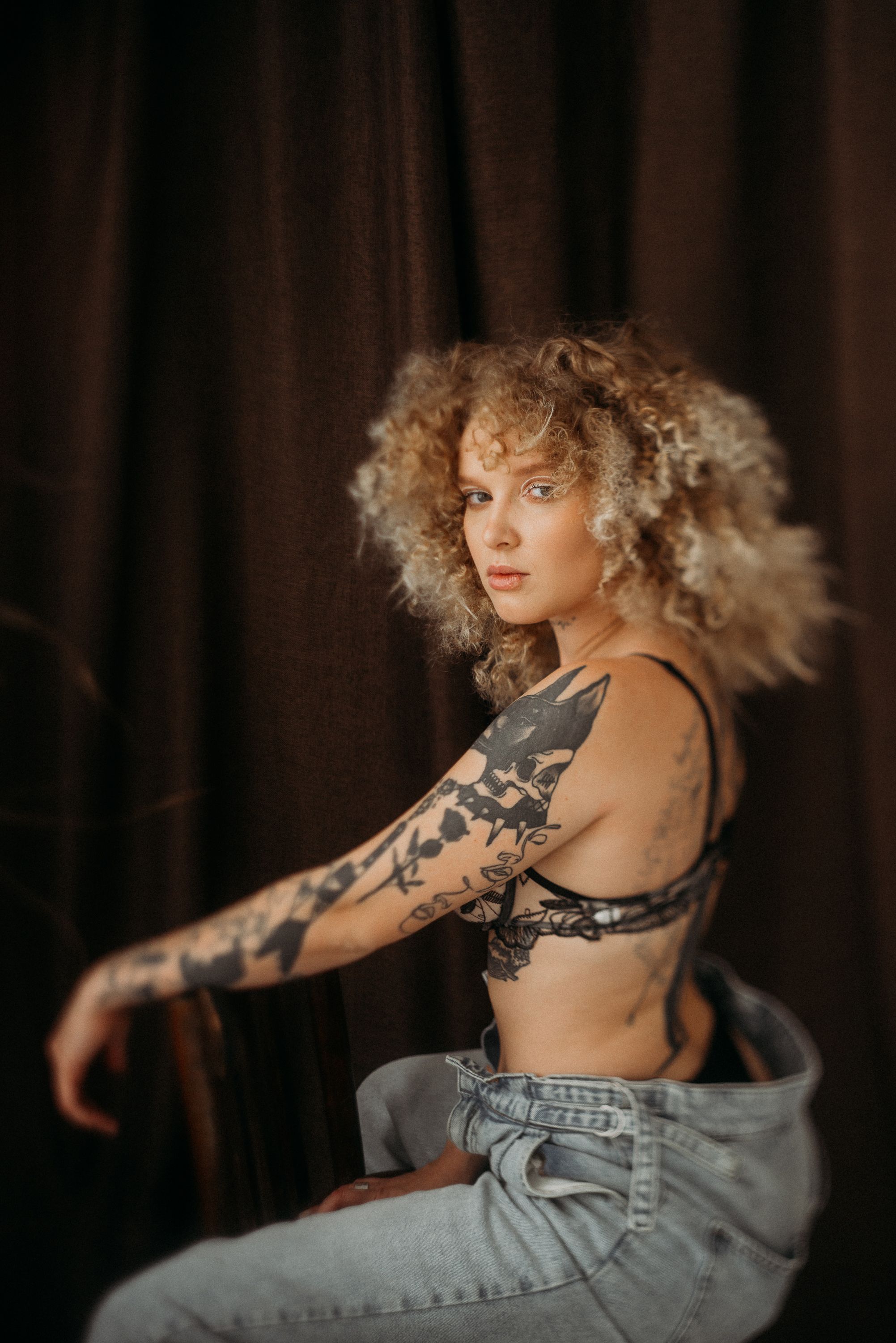 Artistic portrait sequence showing flowing blonde curls and denim against dark background.