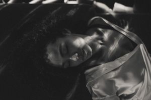 Abstract black and white photography with flowing fabric and ethereal motion blur effects.