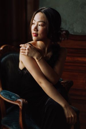 Moody portraits in dark lighting with red lipstick and dramatic shadows.