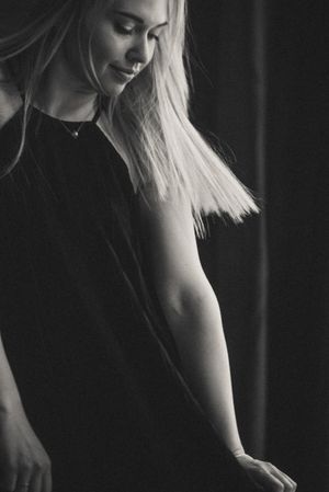 Dramatic black and white portrait series with soft side lighting.