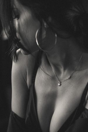 Black and white close-up shots focusing on necklace and collar bones.