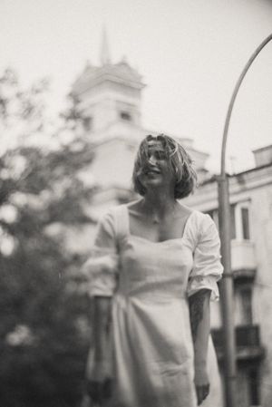 Dreamy black and white outdoor portraits with architectural elements in background.
