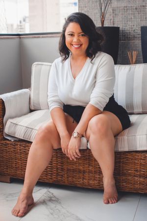 Casual lifestyle photos on a wicker sofa showing relaxed poses in comfortable attire.
