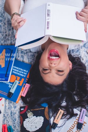 Study materials and colorful notebooks spread out on a blue patterned floor.