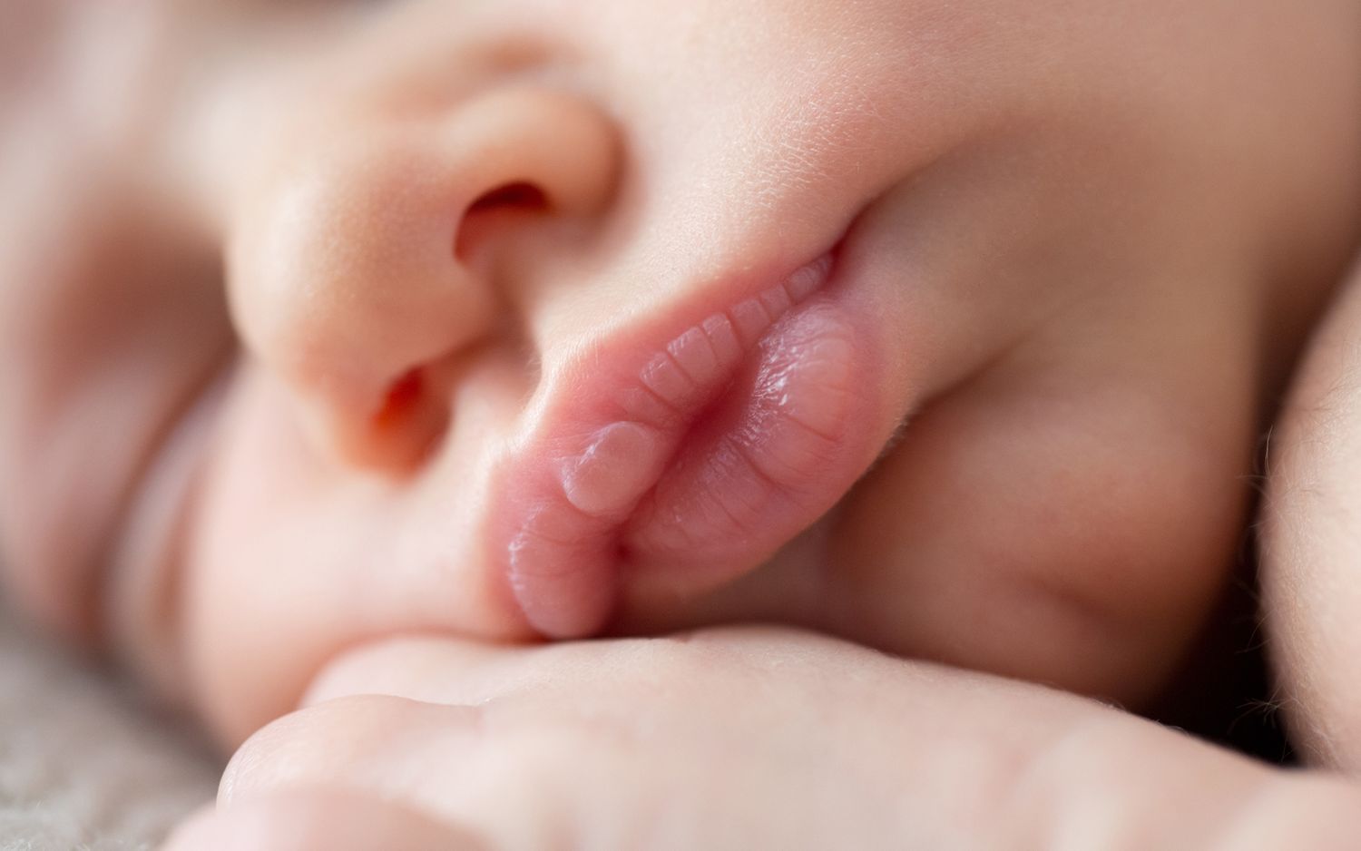 macro image of newborn's lips while sleeping